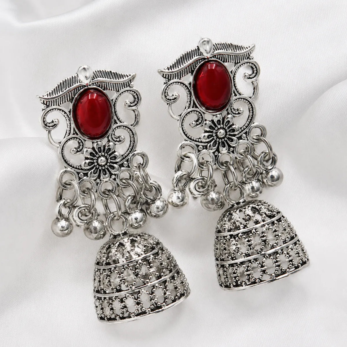 Red stone oxidised filigree jhumka earrings
