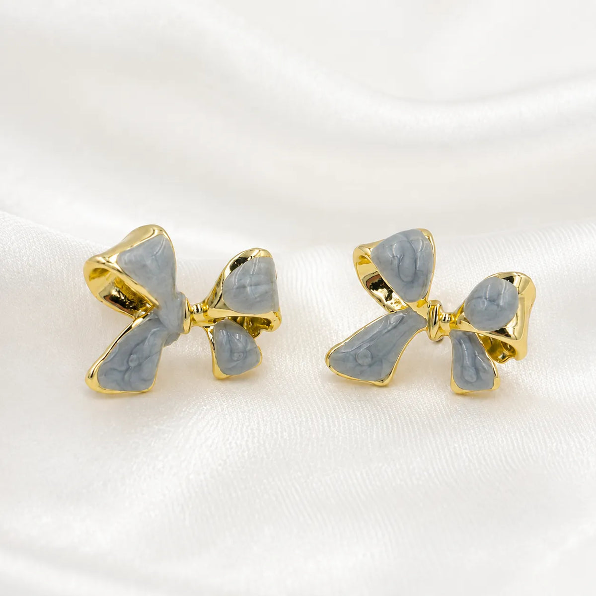 Slate blue bow gold rim stud earrings