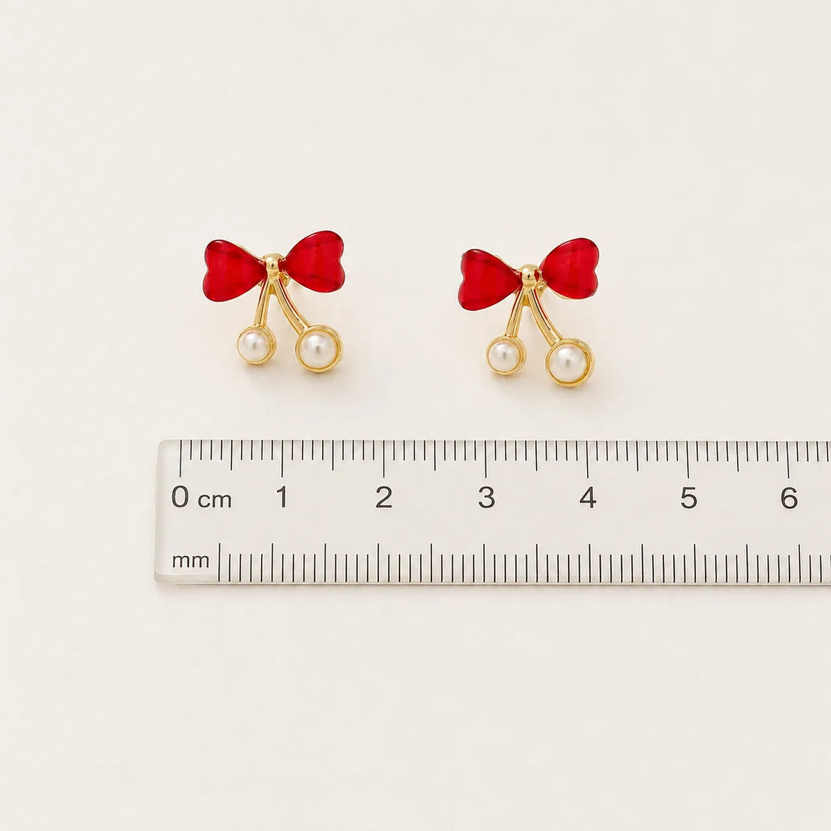 Crimson bow pearl drop studs