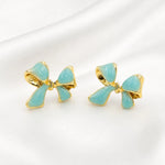 Load image into Gallery viewer, Aqua Bow Gold Rim Stud Earrings
